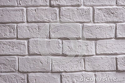 A wall of white brick aging by time and faded by wheather. A stone work and background for house design Stock Photo