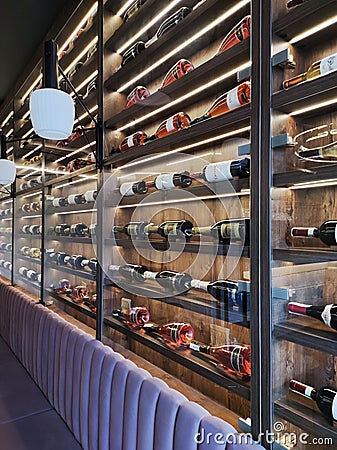 Wall of wine bottles collection and interior of restaurant Editorial Stock Photo