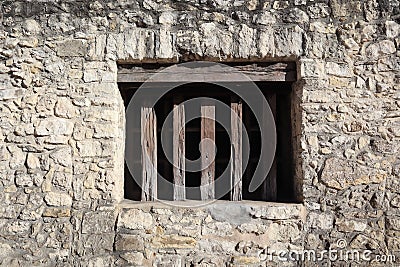 Wall with wood window slats on the side of The Alamo in San Antonio, Texas Stock Photo