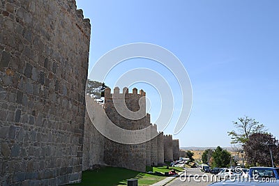 The wall of Ãvila is a Romanesque military fence that surrounds the old quarter of the Spanish city of Ãvila Editorial Stock Photo