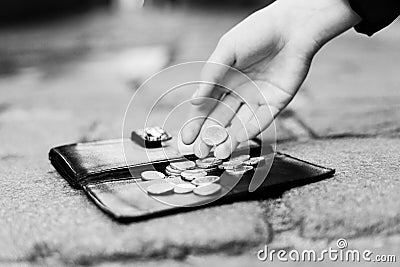 The wallet with coins on sidewalk street, forgotten money Stock Photo
