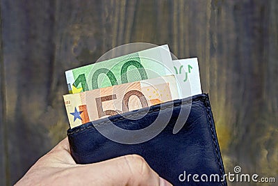 Wallet and currency on a gray wooden background Stock Photo