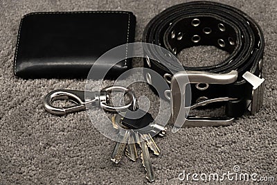 Wallet, keys and leather belt on black background, men accessories concept Stock Photo