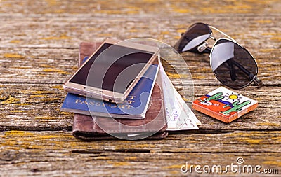 A wallet, money and other items are on the table of old boards Stock Photo