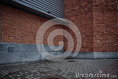Walls of red brick building and grey brick floor Stock Photo