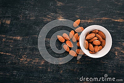Walnut almonds. On a black wooden background. Stock Photo