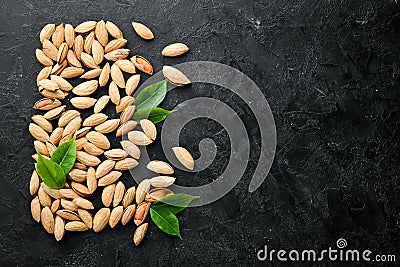 Walnut almonds in the shell. Nuts on a black stone background. Top view Stock Photo
