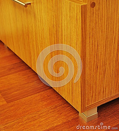 Walnut cabinet and corner detail on mahogany parquet in luxury house Stock Photo