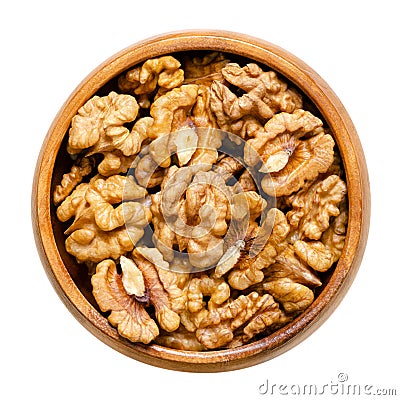 Walnut kernel halves, shelled and dried seeds, in a wooden bowl Stock Photo