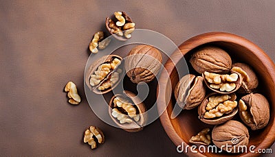 Walnut kernel halves, in a wooden bowl. Close-up, from above on colored background. Healthy eating Walnut concept. Super foods Stock Photo
