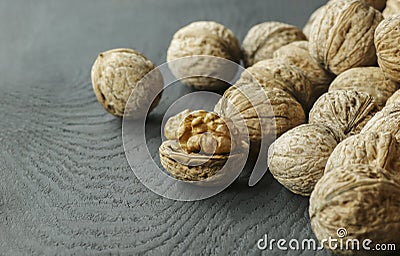 Walnut kernel with shell on wooden backdrop. healthy food for brain. walnut background Stock Photo