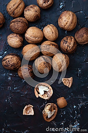 Walnut kernels and whole walnuts on rustic background. top view Stock Photo