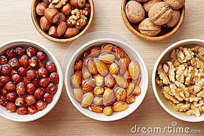 Walnuts, almonds and hazelnuts soaking in water Stock Photo