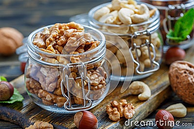 Walnuts and cashews in glass jars. Stock Photo