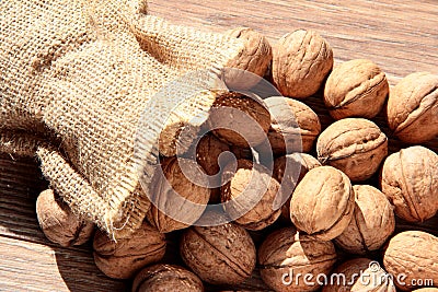 Walnuts are emptied out of the bag. Scattered nuts Stock Photo