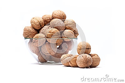 Walnuts lie in a glass bowl isolated on white Stock Photo