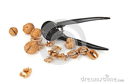 Walnuts with a nutcracker on a white background Stock Photo