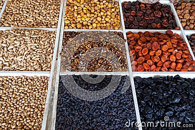 Walnuts, pistachios, bodom, dried apricots, prunes, raisins are sold in boxes at the Chorsu bazaar in Tashkent in Uzbekistan Stock Photo