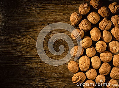 Walnuts scattered on a wooden table Stock Photo