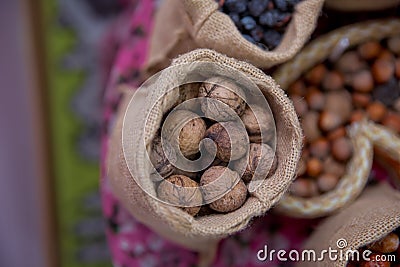 Walnuts in a small bag of containers . Close-up of walnuts as background . Mix of hazelnut with hard shell . Dried and walnuts, Stock Photo