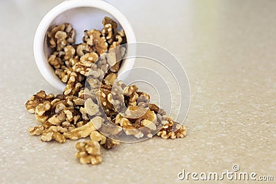 Walnuts Spilling Out Of A Container, Positioned Left Stock Photo