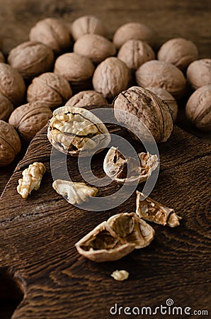 Walnuts on wooden background. Vegetarian, brain nutrition. Close up, vertical Stock Photo