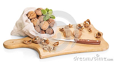 Walnuts, wooden board and knife isolated on white Stock Photo