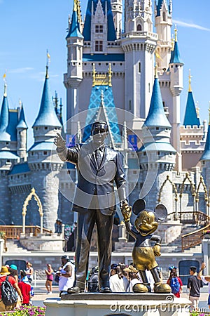 Walt Disney and Mickey mouse statue in front of Cinderella princess castle at Disney world Florida Editorial Stock Photo