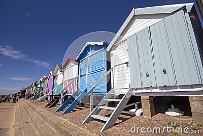 Wooden beach huts on the coastline heading towards Frinton. Walton on the Naze Editorial Stock Photo