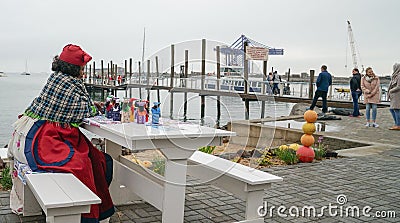 Herero woman traditional attire sitting by tourist jetty Editorial Stock Photo