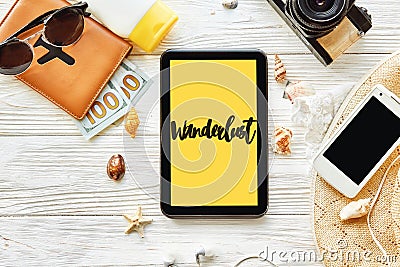 Wanderlust text sign. travel concept text on yellow tablet scre Stock Photo