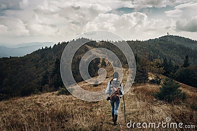 wanderlust and travel concept with space for text. hipster traveler on top of mountains, amazing view. stylish woman hiking. atm Stock Photo