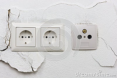 Wall plaster loosens around sockets Stock Photo