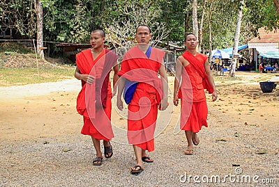 three buddhist monks in red robes on nature background Editorial Stock Photo