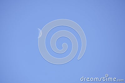 Waning Crescent Day. Lunar phase, bright illuminated moon during the day. Stock Photo