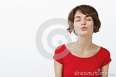 Wanna feel your love. Lovely romantic cute woman lean foward give kiss fold lips close eyes happily awaiting muah Stock Photo