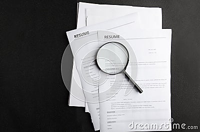 Wanted new employees.Free vacancy concept.Top view of stack of resume on black background Stock Photo