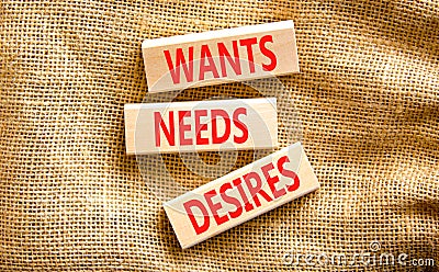 Wants needs and desires symbol. Concept words Wants Needs Desires on wooden blocks. Beautiful canvas table canvas background. Stock Photo