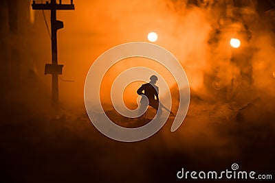 War Concept. Military silhouettes fighting scene on war fog sky background. Sappers clears mines at the site of recent fighting Stock Photo