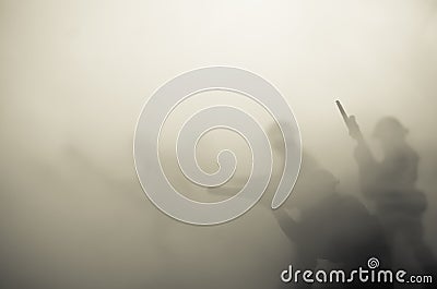 War Concept. Military silhouettes fighting scene on war fog sky background, World War Soldiers Silhouettes Below Cloudy Skyline At Stock Photo