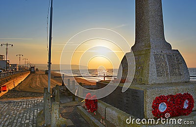 War Memorial and Red Poppy Wreaths at Sunrise Editorial Stock Photo