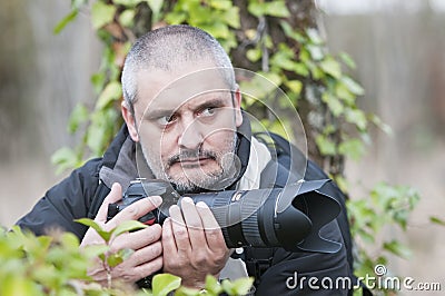 War photojournalist in a wild jungle. Stock Photo