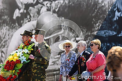 War veteran lays flowers to the monument on Victory Day Editorial Stock Photo