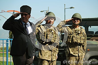 A War Veteran and Soldiers Saluting in Front of Military Truck Editorial Stock Photo