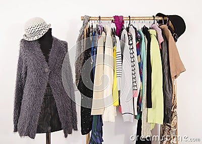 Wardrobe with clothes arranged on hangers and a winter outfit on a mannequin. Stock Photo