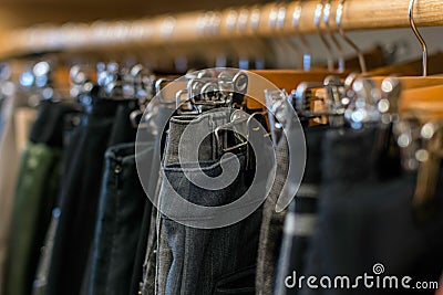 Wardrobe full of clothes: jeans, pants Stock Photo