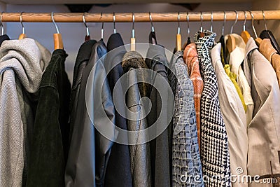 Wardrobe full of different color, material and texture clothes, Stock Photo