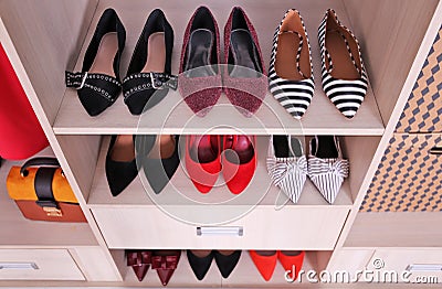 Wardrobe shelves with different shoes Stock Photo
