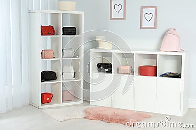 Wardrobe shelves with different stylish bags indoors. Stock Photo