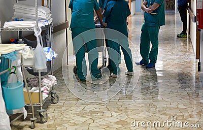 Consult among surgeons and nurses in hospital corridors among a group Stock Photo